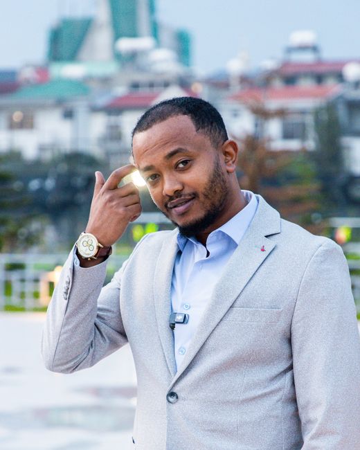 Teshome Girma with Addis Ababa buildings behind him